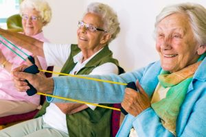 older adults stretching with exercise bands