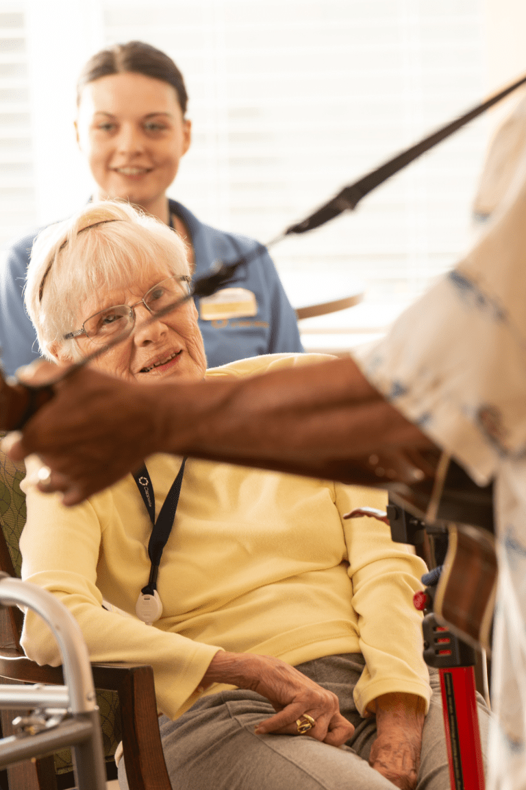 residents enjoying listening to live guitarist portrait