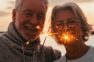 older couple holding up sparklers